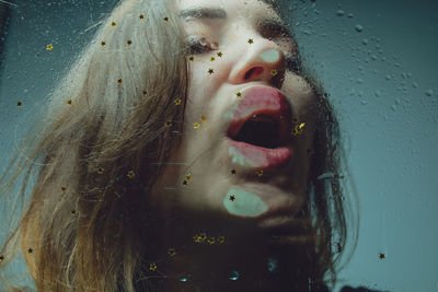 Close-up of woman with wet glass