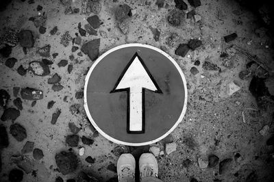 High angle view of road sign on sand