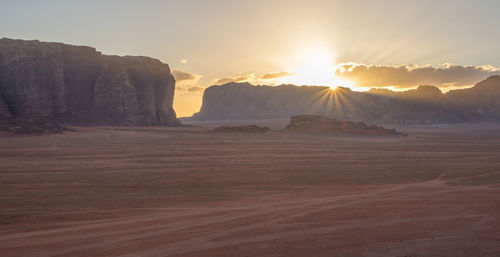 Scenic view of rocky mountains against sky during sunset