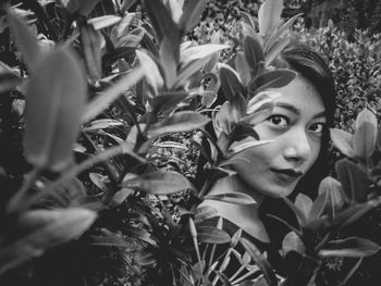Close-up portrait of young woman with flowers