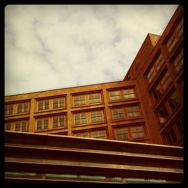 architecture, building exterior, built structure, sky, low angle view, cloud - sky, window, transfer print, cloudy, building, city, auto post production filter, cloud, modern, residential building, residential structure, overcast, glass - material, office building, outdoors