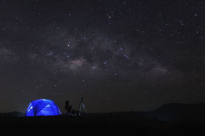 Low angle view of silhouette tent against sky at night