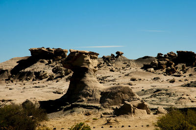 Rock formation on land against clear sky