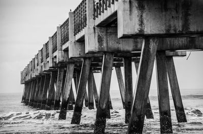 Wooden pier on sea against sky