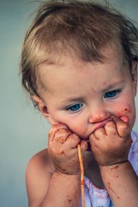 Close-up portrait of cute boy eating ice