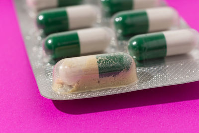 Close-up of capsules over pink background