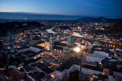 High angle view of illuminated buildings in city at night