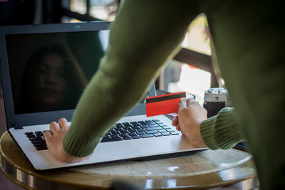 Midsection of man using mobile phone