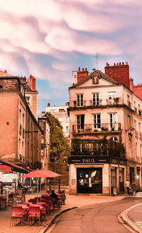 Street amidst buildings in town against sky