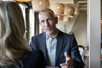 Serious businessman talking to client in restaurant