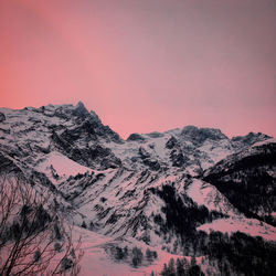 Scenic view of snowcapped mountains against sky during sunset