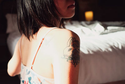 Rear view of woman with tattoo on back