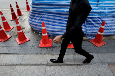 Low section of man with red umbrella