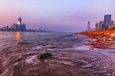 City at waterfront during sunset