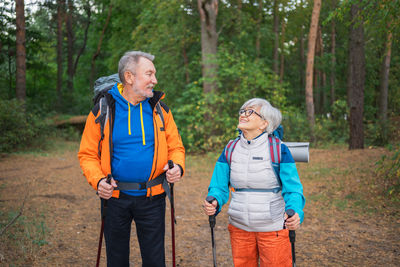 Portrait of senior couple walking in forest