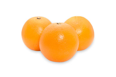 Close-up of orange fruit against white background