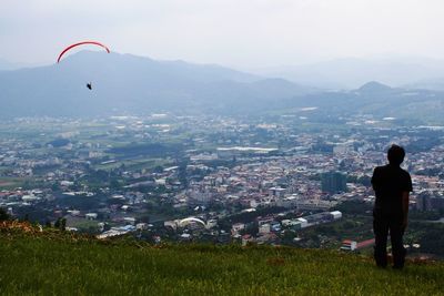 Woman standing on mountain against sky