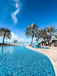 Pool with palm trees on the beach of the caribbean sea on coche in venezuela to sunsol punta blanca