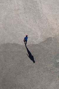 High angle view of man walking on street