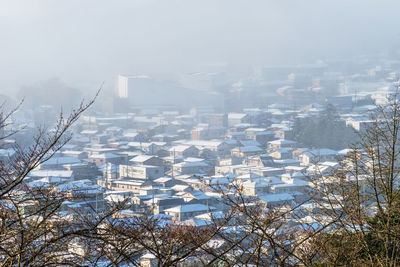 Cityscape against sky during winter