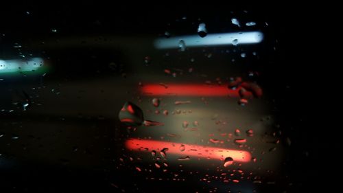Close-up of wet car windshield at night