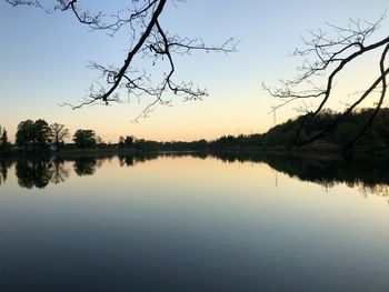 Scenic view of lake against sky at sunset