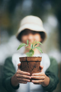 Woman holding potted plant