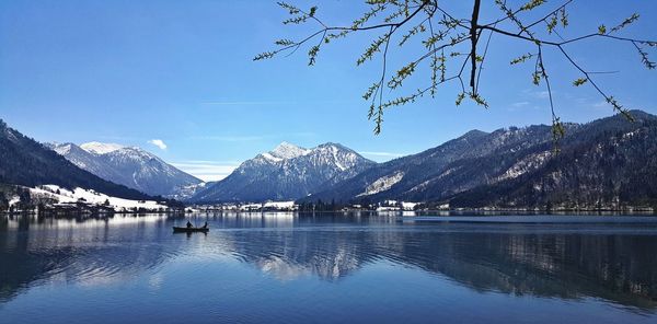 Scenic view of lake by mountains against sky