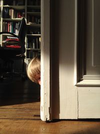 Cropped image of boy hiding at home