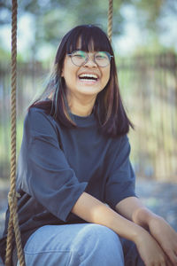 Asian teenager laughing with happiness mood on location