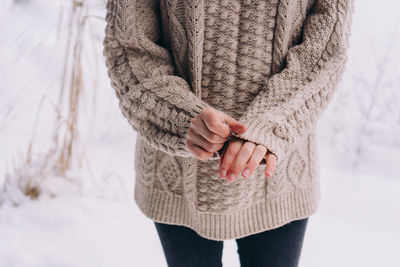 Midsection of woman standing in snow