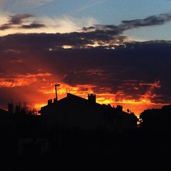 Silhouette of built structure against dramatic sky