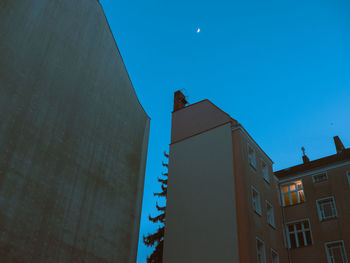 Low angle view of modern buildings against clear blue sky