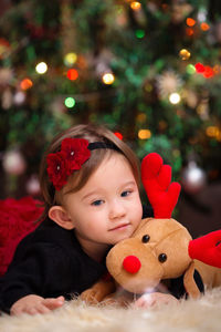 Portrait of boy with toy in christmas tree