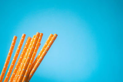 Low angle view of orange against blue sky