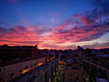 High angle view of illuminated buildings against sky during sunset