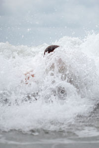 Close-up of man surfing in sea