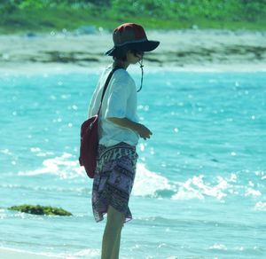 Rear view of man standing on beach