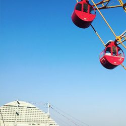 Low angle view of ferris wheel against clear sky