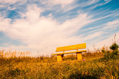 Lifeguard hut on field against sky