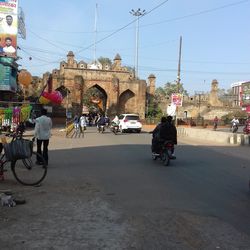 People riding motorcycle on city street