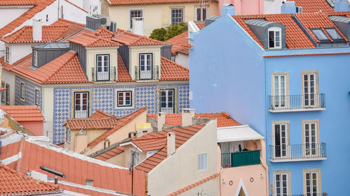 Colourful walls of the buildings of lisbon, with orange roofs. tourism and real estate concept. 