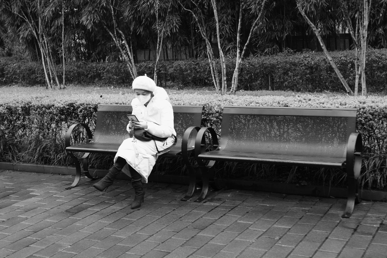 MAN SITTING IN PARK BENCH