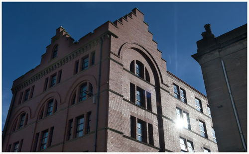 Low angle view of illuminated building against sky