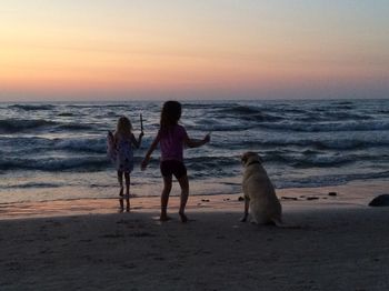 People on beach at sunset