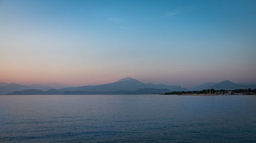 Scenic view of sea against clear sky during sunset