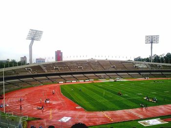 Scenic view of soccer field against clear sky