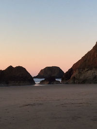 Scenic view of sea against clear sky during sunset