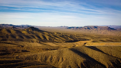 Scenic view of arid landscape against sky