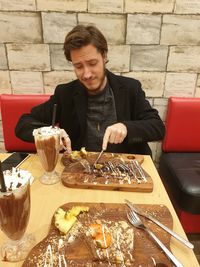 Young man sitting in restaurant